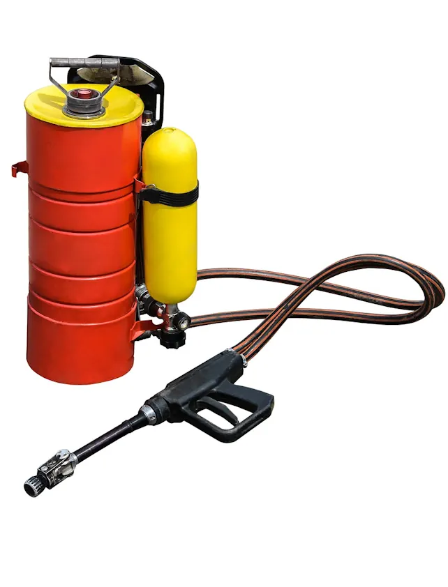 photo of pesticide canister with hose and spray gun attached